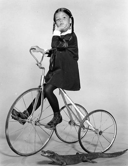 wednesday on a tricycle with an alligator