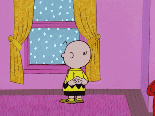 charlie brown looking out a snowy window