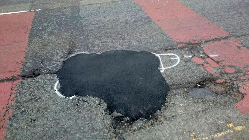 Painting penises around potholes 4
