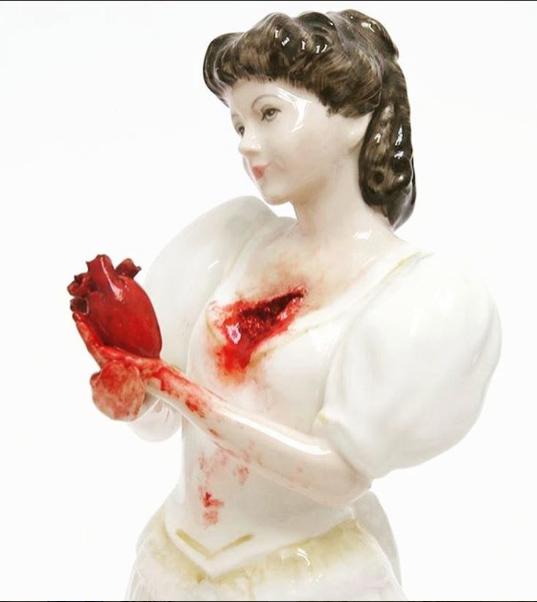 porcelain statue holding her own heart