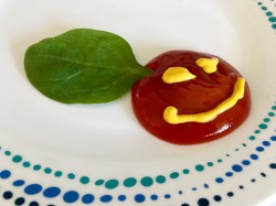 Condiment smiley face with spinach