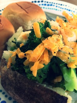 Shredded cheese on brocolli and baked potato