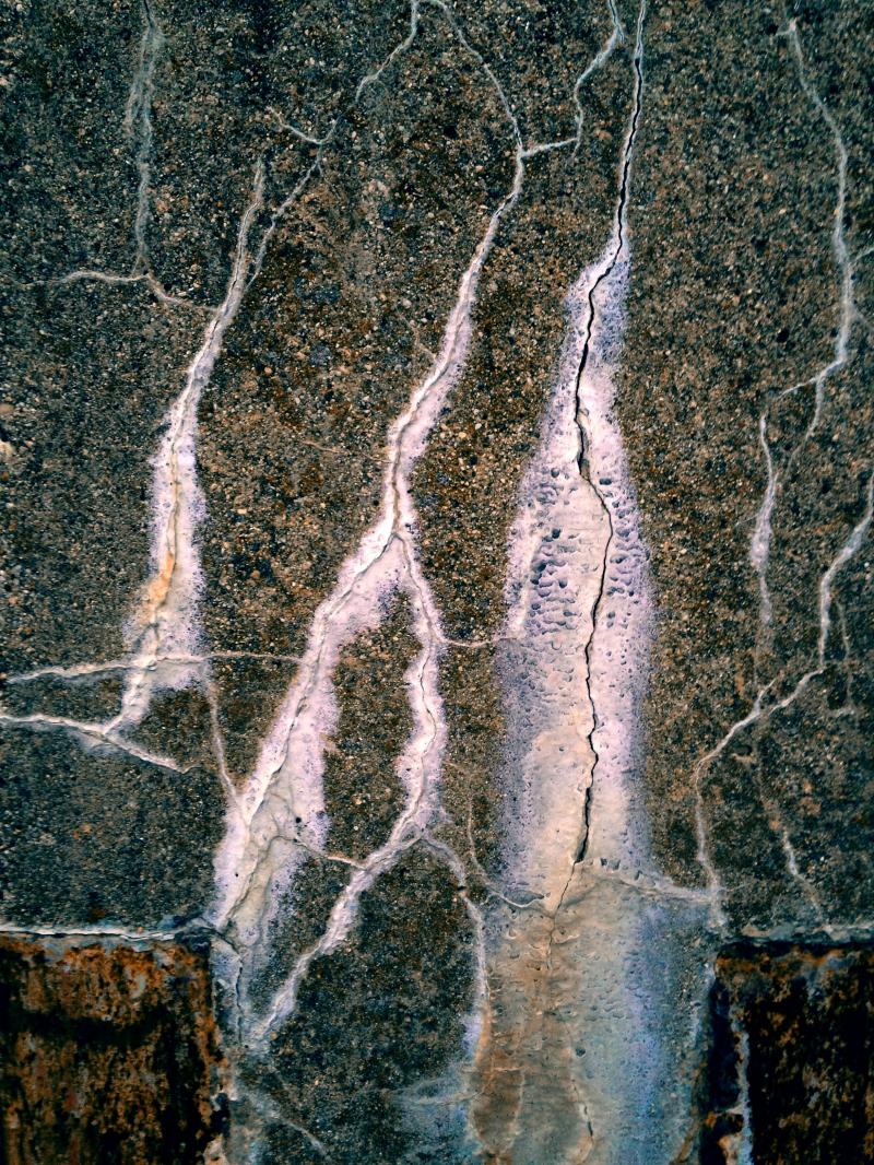 Cracked and patched cement wall