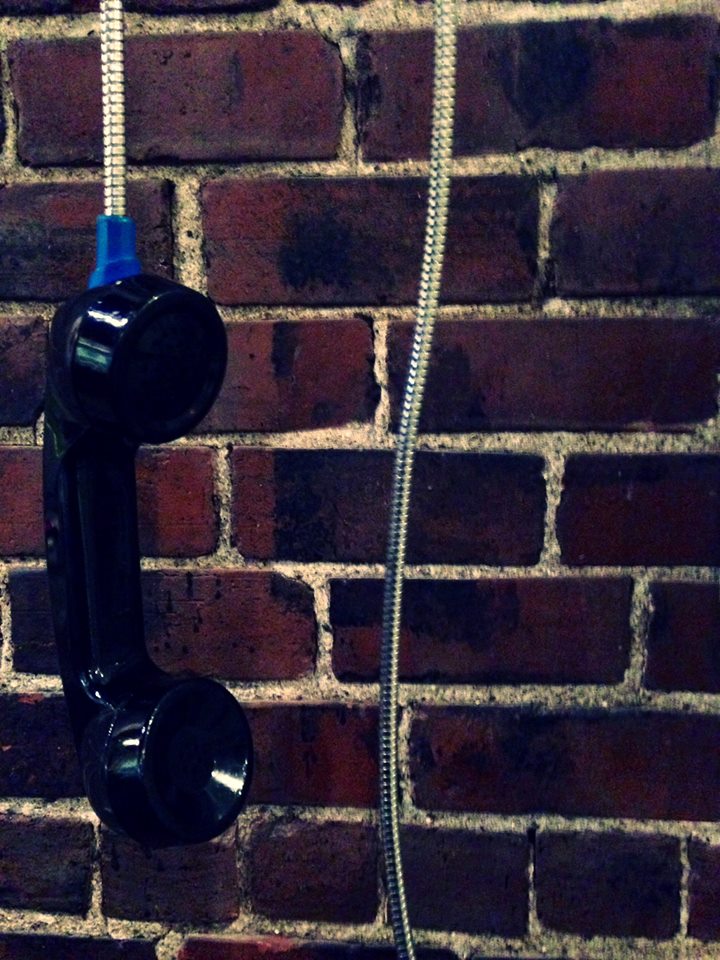 Corded phone against brick