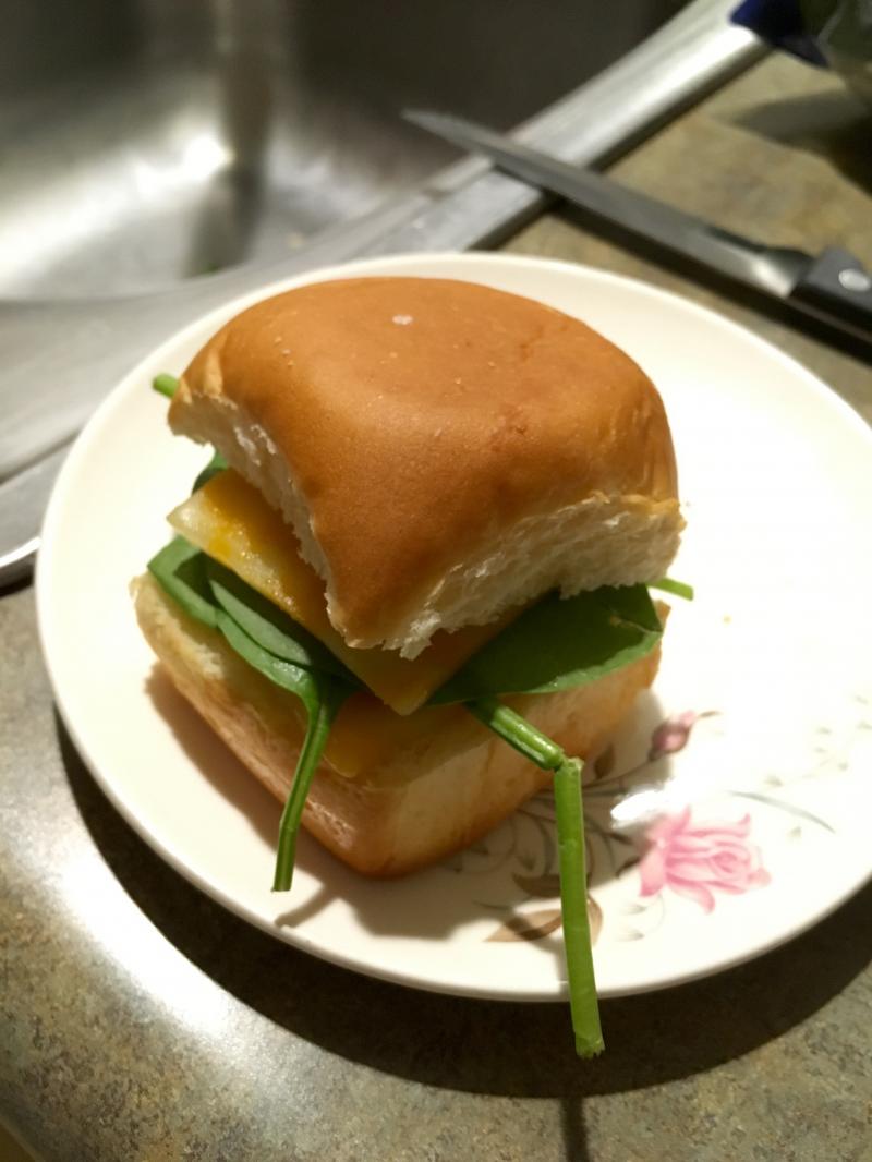 Hawaiian roll toasted with melted Colby and baby spinach