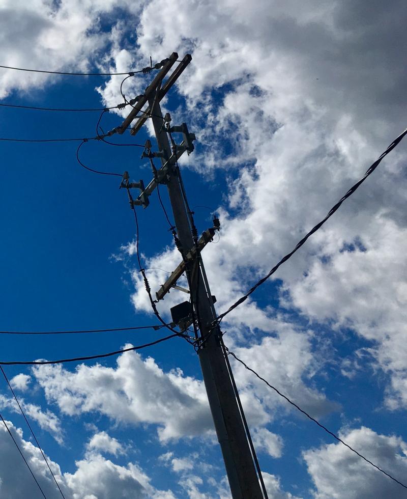 Telephone poles against blue skies 2