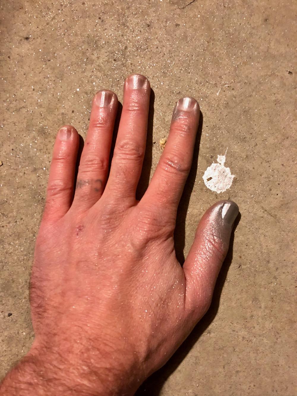 Left hand with silver spray paint