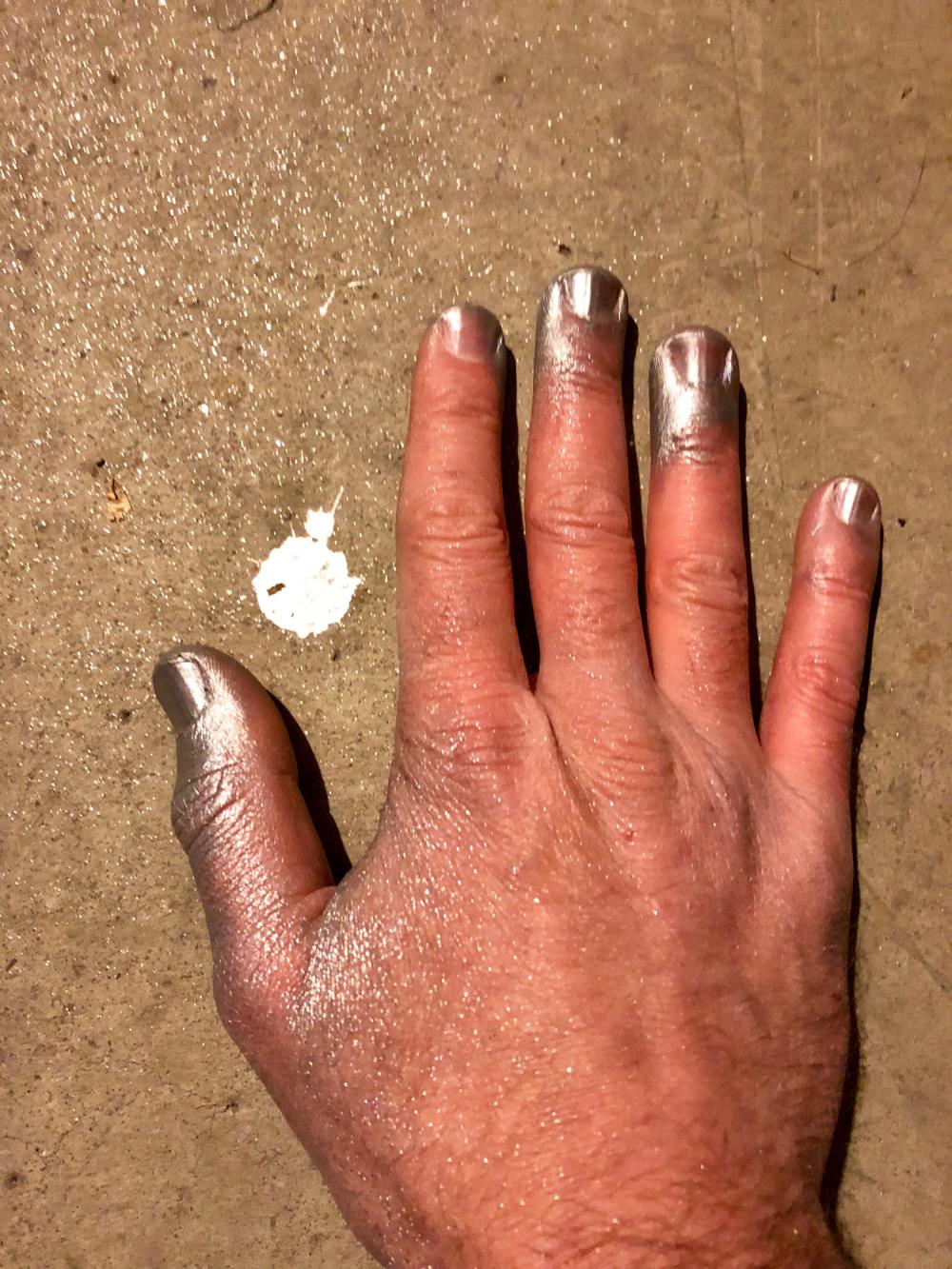 Right hand with silver spray paint