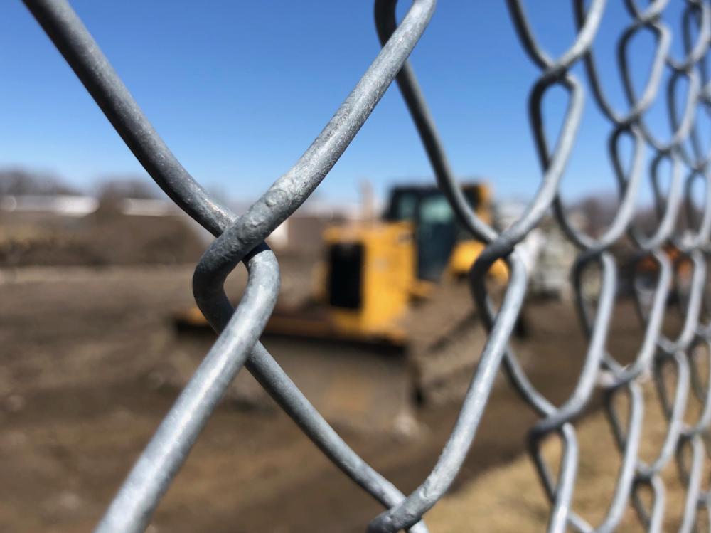 Bulldozer behind the chain link