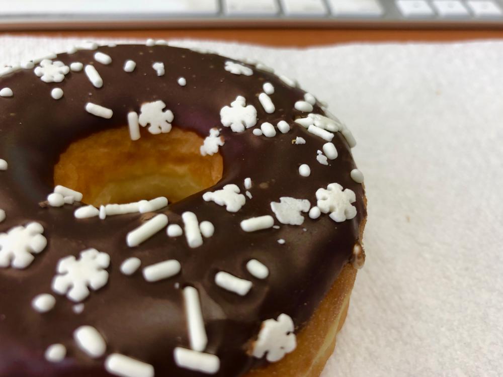 Chocolate donut with snowy sprinkles
