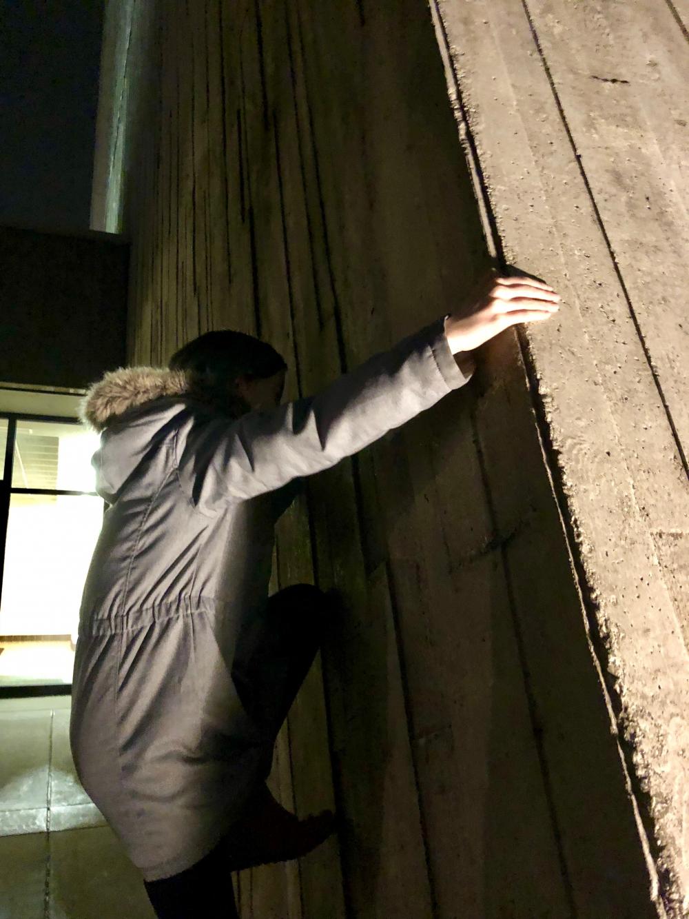 Maggie climbing Fermilab's Wilson Hall
