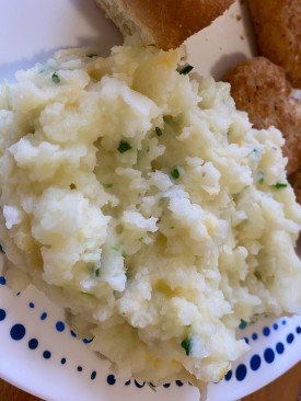 Mashed potatoes with broccoli sprouts and cheddard chees