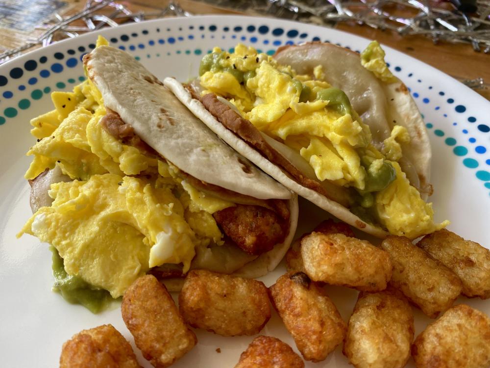 Tortillas, refried beans, provolone, tater tots, scrambled eggs, and green sauce 2