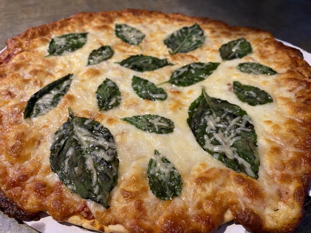 a frozen pizza with fresh basil and parmesan 1